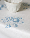 White ceramic bowl on a white surface with blue floral patterns