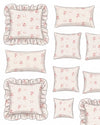 Set of decorative pillows with floral patterns and ruffled edges on a white background