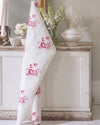 White fabric with pink floral pattern in a decorative room setting