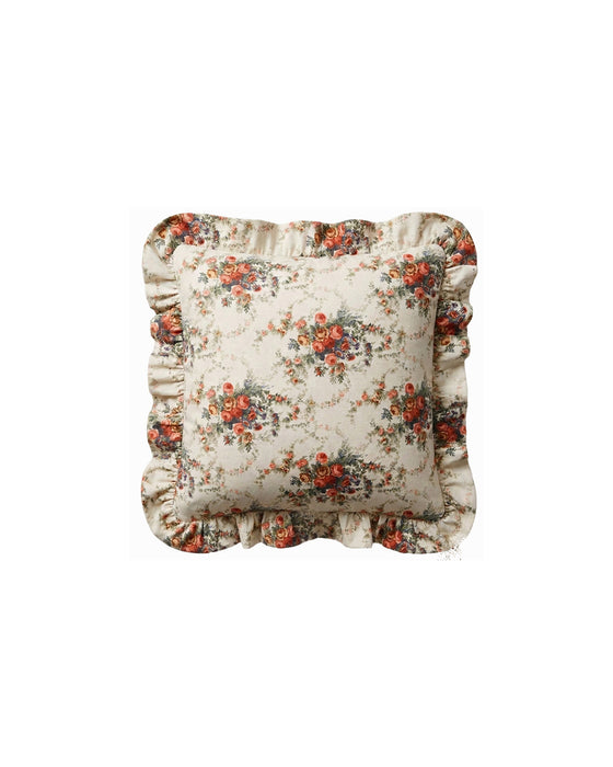 Floral patterned pillow with ruffled edges on a white background