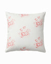 White pillow with pink floral pattern on a white background