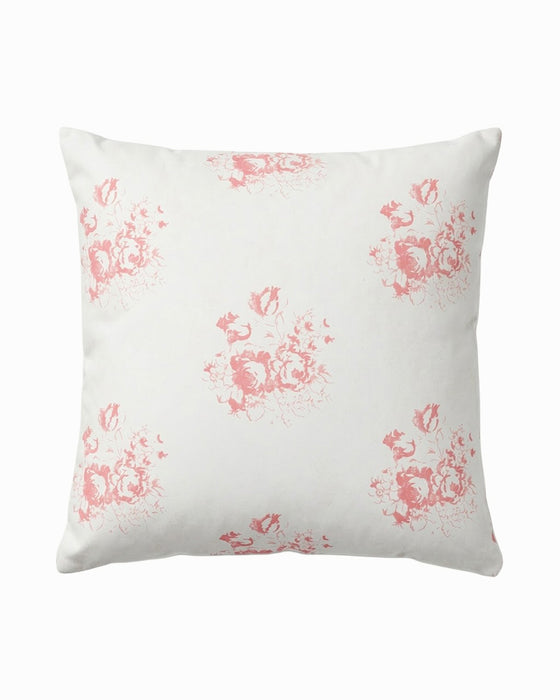White pillow with pink floral pattern on a white background