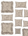 Collection of decorative pillows with floral patterns and ruffled edges on a white background.