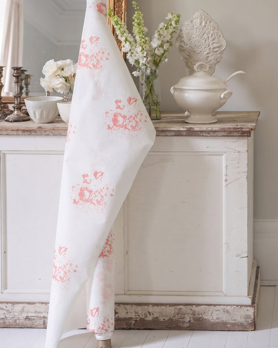 Floral-patterned fabric draped over a cabinet in a decorative room.