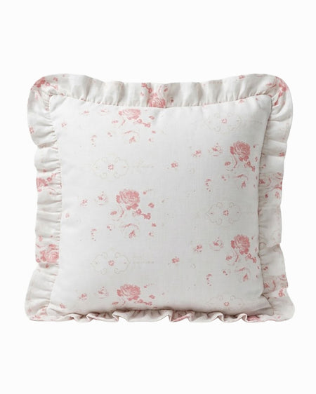 Floral-patterned pillow with ruffled edges on a white background