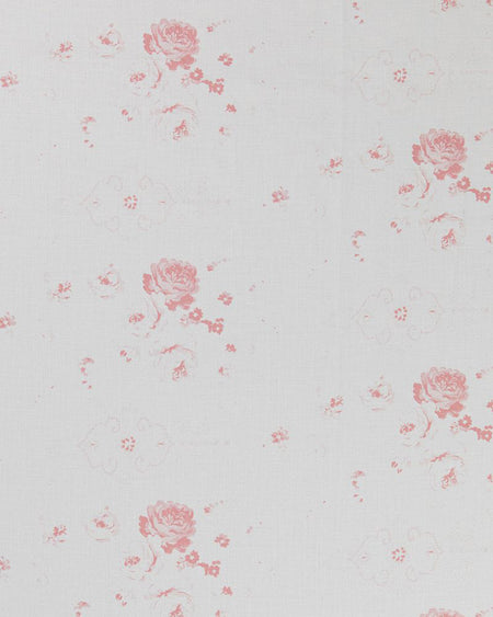 A close-up image of white linen fabric with a repeated floral pattern in a pink hue.