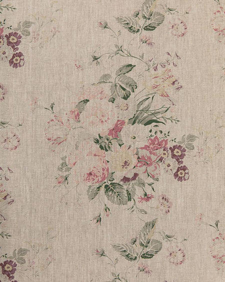 A fabric with a floral pattern in shades of purple, green, and pink on a natural linen background.
