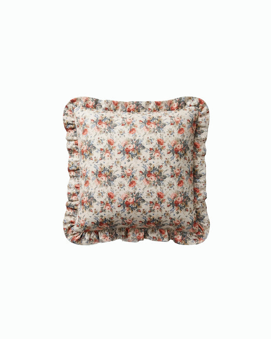 Floral patterned cushion with ruffled edges on a white background