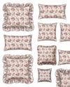 Set of floral patterned pillows with ruffled edges on a white background
